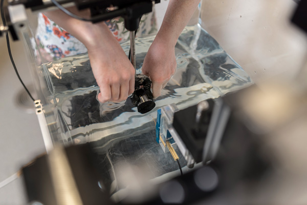 Image of research positioning an ultrasound transducer in a tank.